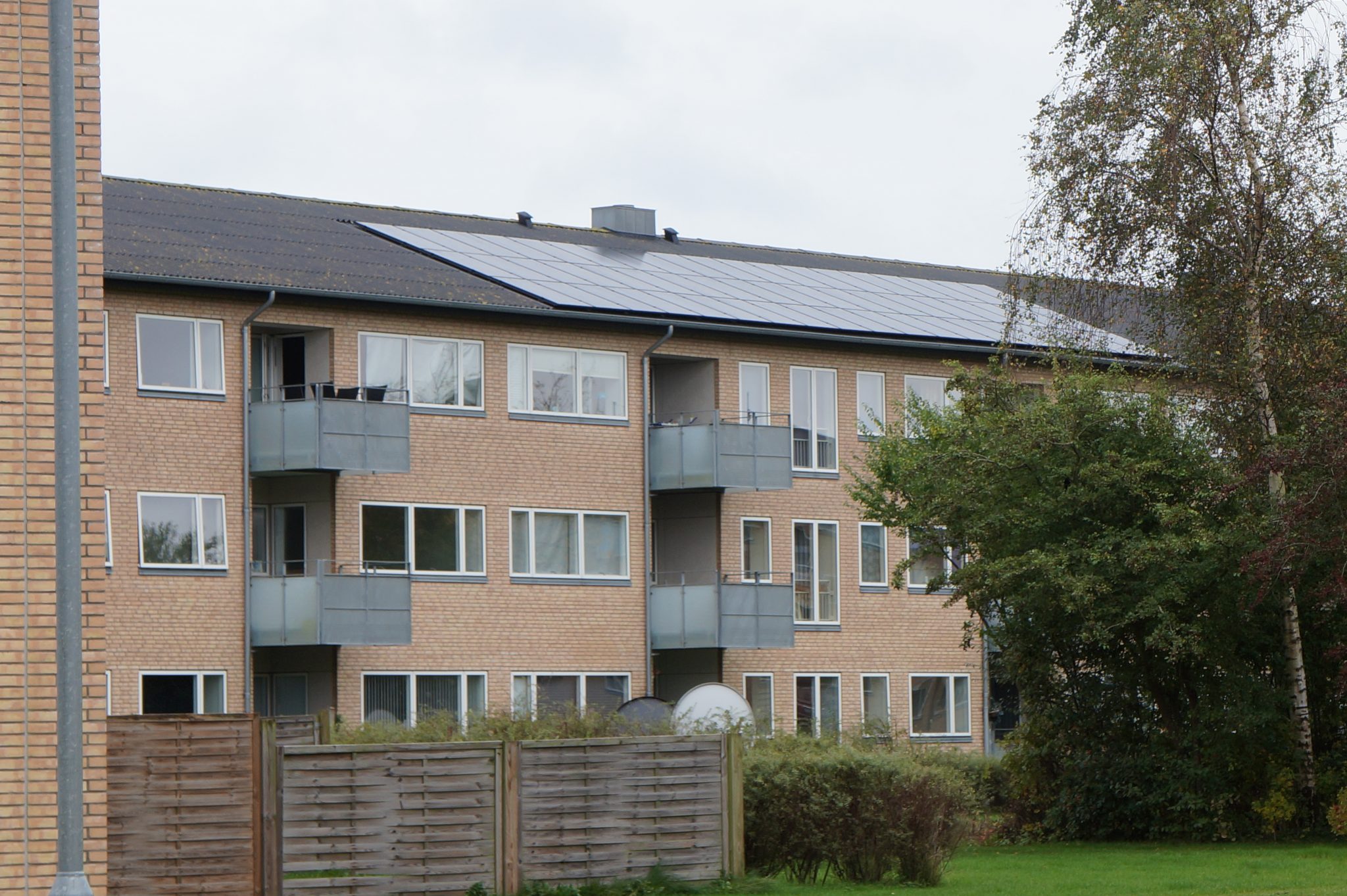 Three storey demo building with integrated solar PV panels towards East. Photo: DEM Danish Energy Management